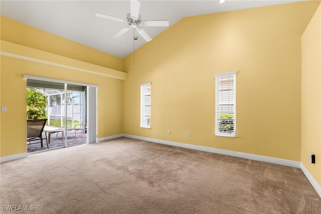 spare room featuring ceiling fan, carpet floors, and high vaulted ceiling