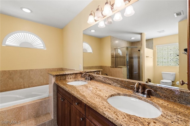 full bathroom with toilet, plenty of natural light, vanity, and shower with separate bathtub