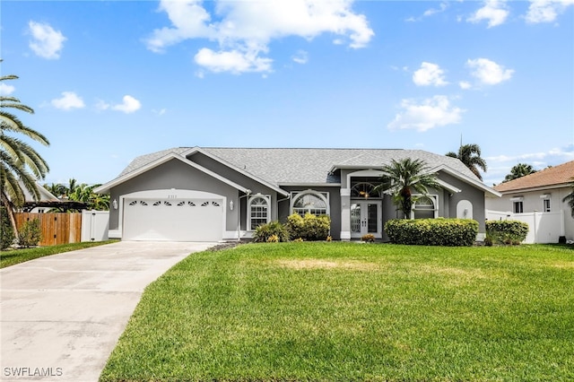 ranch-style house featuring french doors, a front yard, and a garage