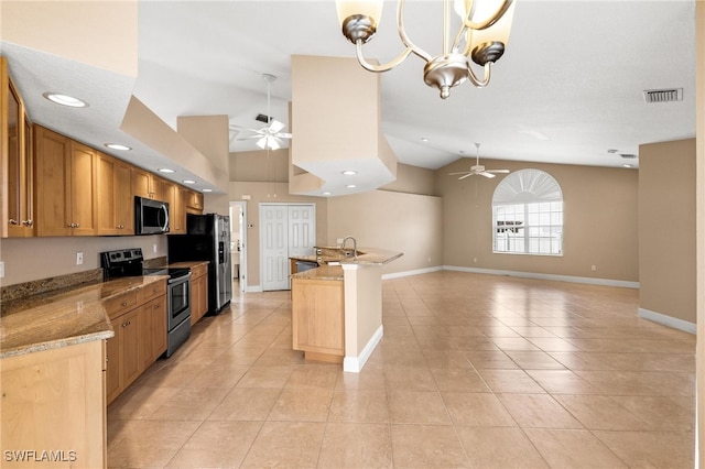 kitchen featuring light stone counters, ceiling fan with notable chandelier, stainless steel appliances, vaulted ceiling, and light tile patterned floors