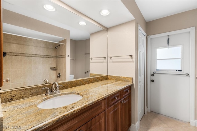 bathroom with tile patterned floors, vanity, and toilet