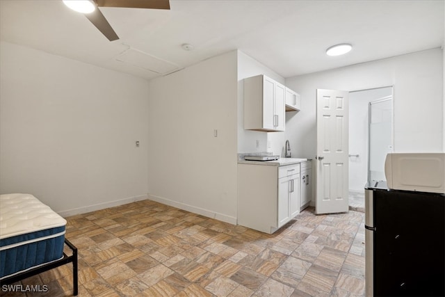 kitchen with white cabinets and ceiling fan