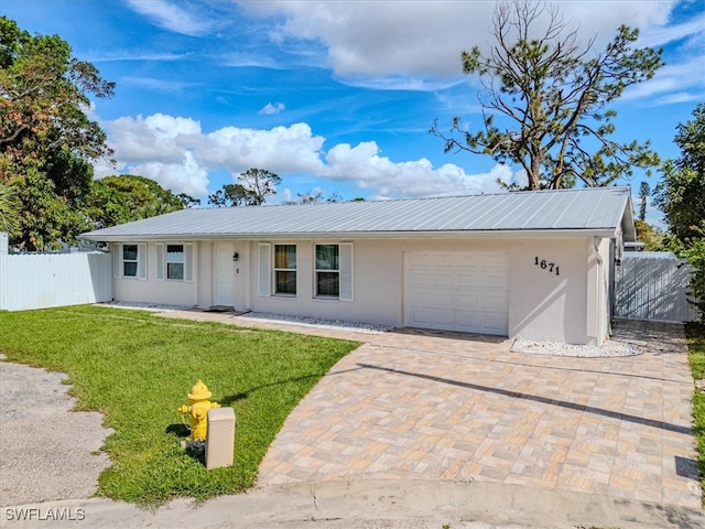 single story home featuring a front yard and a garage