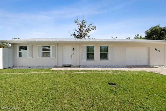 single story home featuring a garage and a front lawn