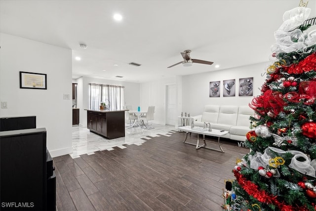 living room with light hardwood / wood-style floors and ceiling fan