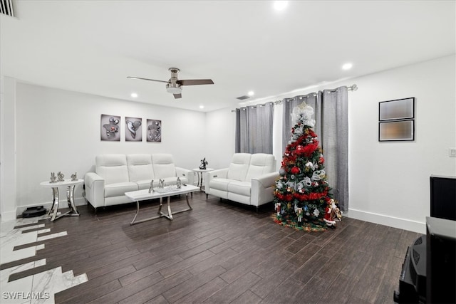 living room featuring dark hardwood / wood-style floors and ceiling fan