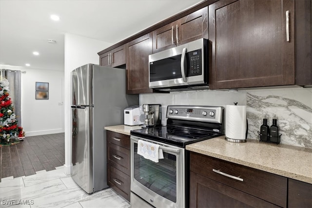 kitchen with backsplash, dark brown cabinetry, and stainless steel appliances