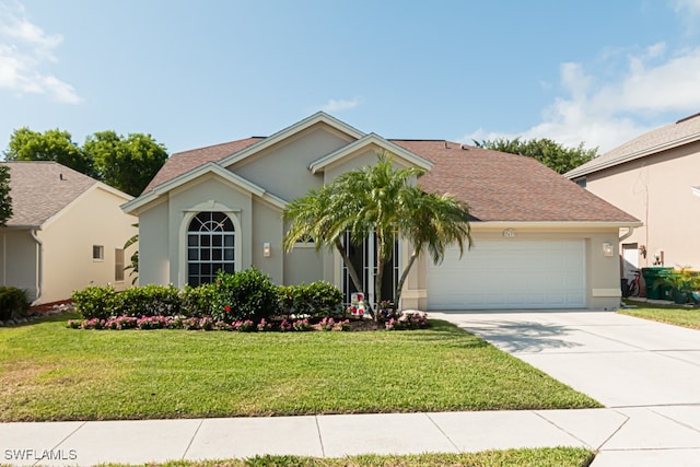 view of front of property featuring a garage and a front lawn