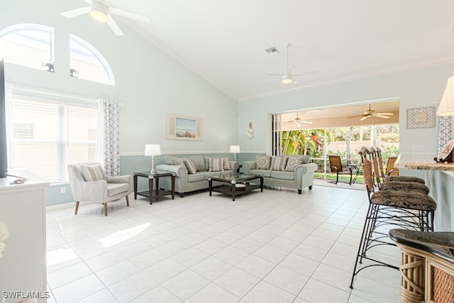 living room featuring a healthy amount of sunlight, light tile patterned floors, visible vents, and ornamental molding