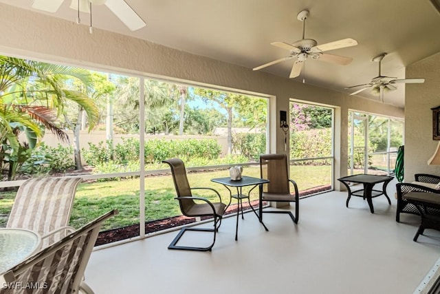 sunroom featuring a healthy amount of sunlight and ceiling fan