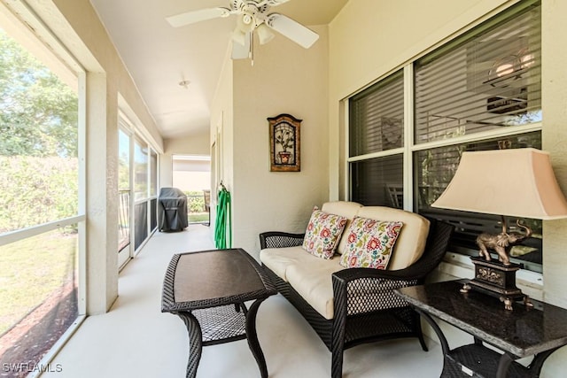 sunroom / solarium featuring ceiling fan