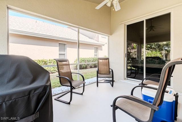 sunroom / solarium featuring a ceiling fan