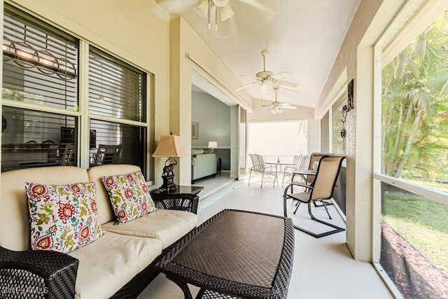 sunroom / solarium featuring ceiling fan and vaulted ceiling