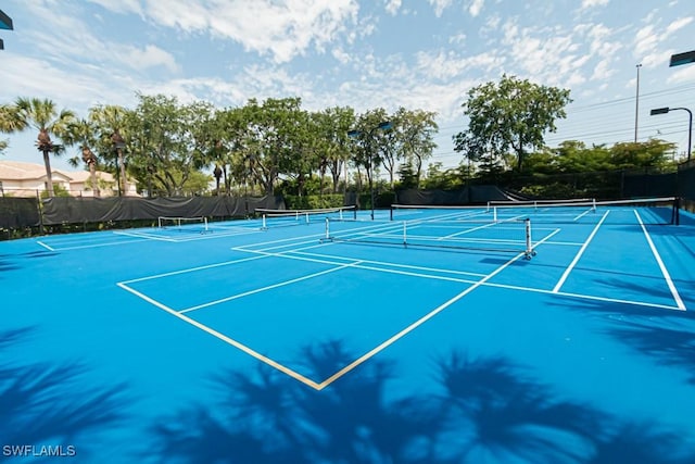 view of sport court featuring fence