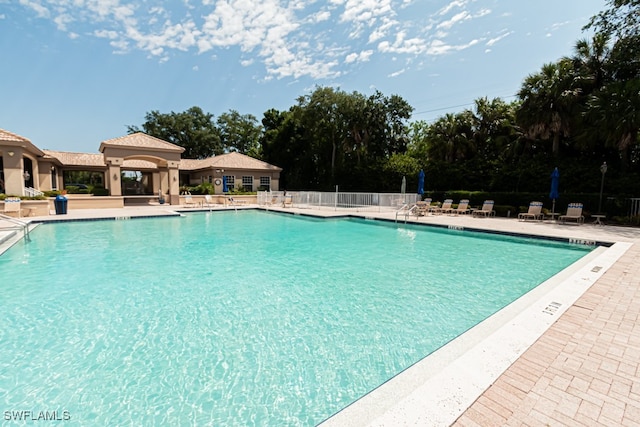 pool featuring a patio area and fence