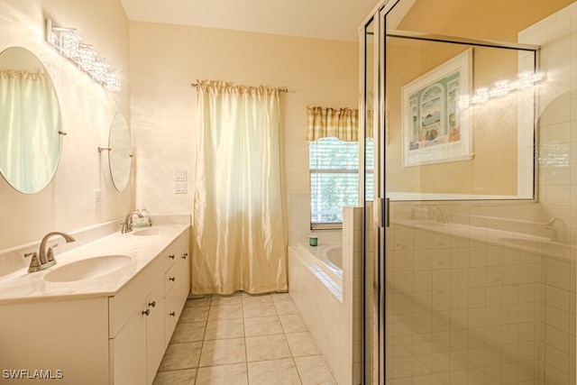 bathroom featuring tile patterned floors, double vanity, a sink, and a bath