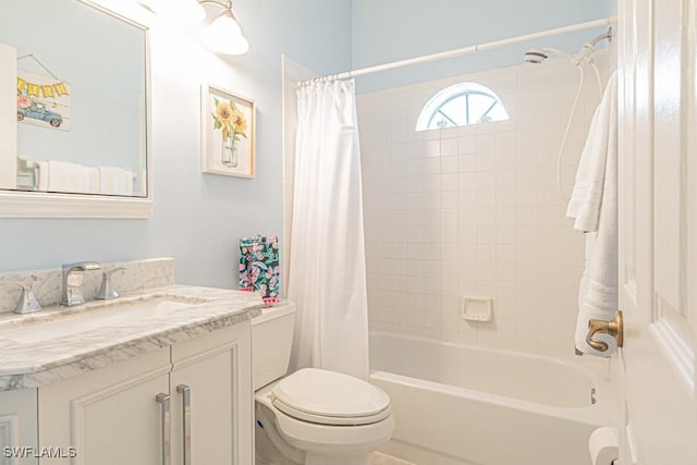 bathroom featuring toilet, shower / tub combo with curtain, and vanity