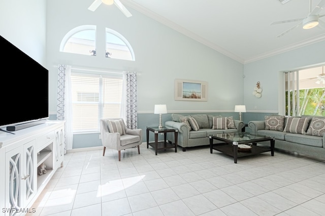 living room featuring a ceiling fan, ornamental molding, high vaulted ceiling, and light tile patterned floors