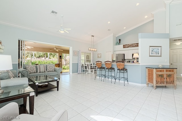 living room featuring light tile patterned floors, visible vents, and crown molding