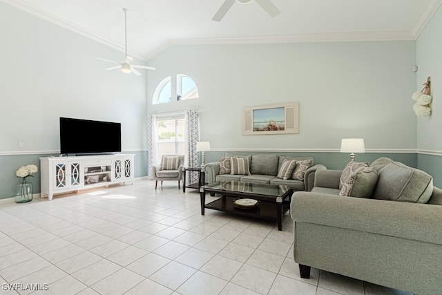 living area with baseboards, a ceiling fan, crown molding, high vaulted ceiling, and light tile patterned flooring