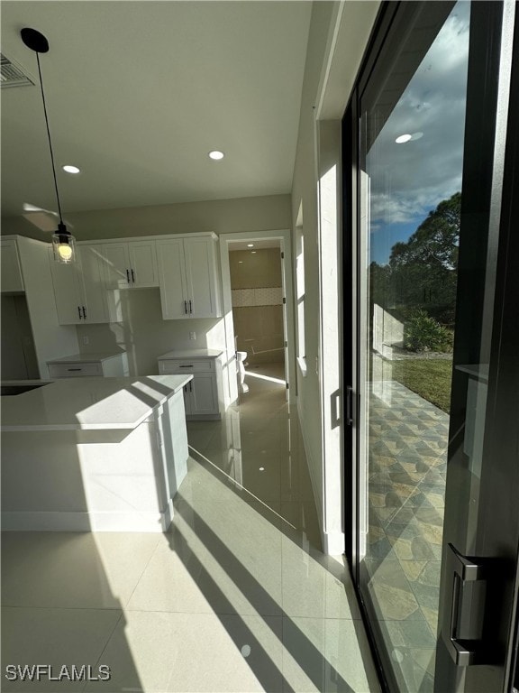 kitchen with white cabinets and decorative light fixtures