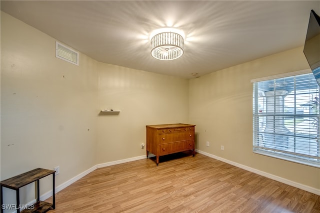 interior space featuring a notable chandelier and light hardwood / wood-style floors