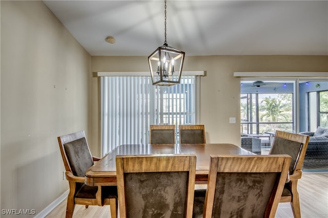 dining room with an inviting chandelier and light wood-type flooring