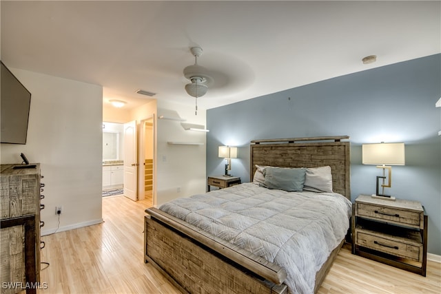 bedroom featuring ensuite bath, ceiling fan, and light hardwood / wood-style flooring