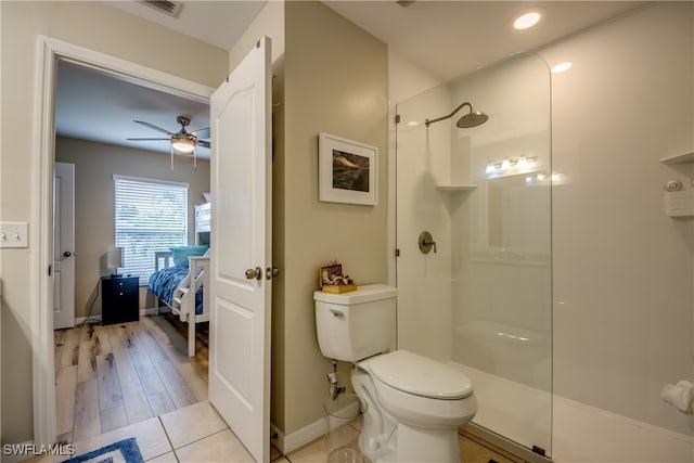 bathroom featuring walk in shower, ceiling fan, toilet, and hardwood / wood-style flooring