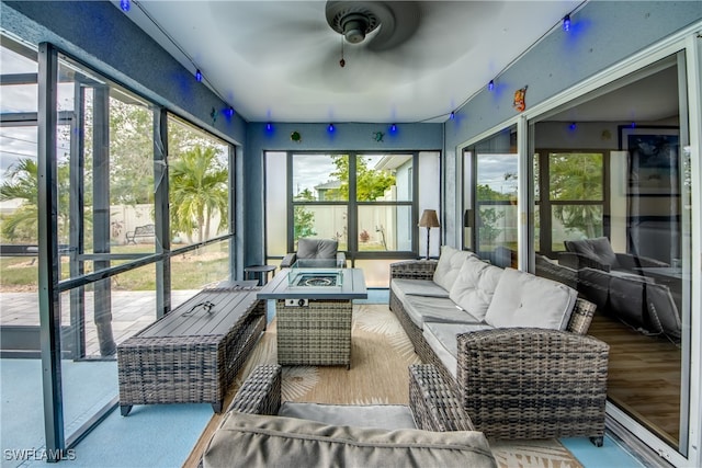 sunroom featuring ceiling fan