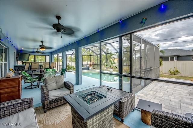 sunroom / solarium with ceiling fan and a pool