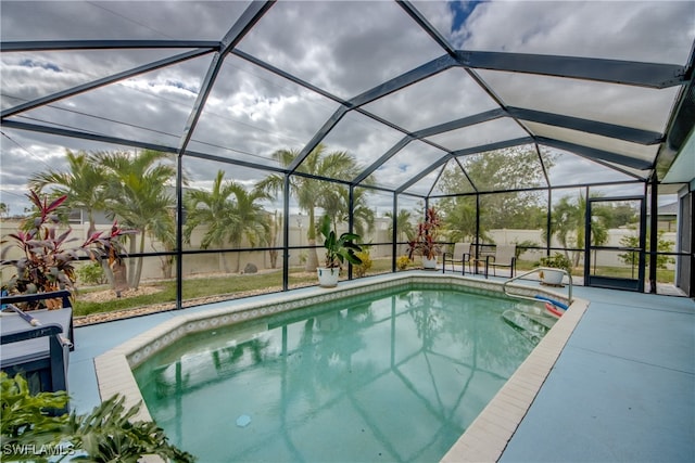 view of swimming pool with a lanai and a patio