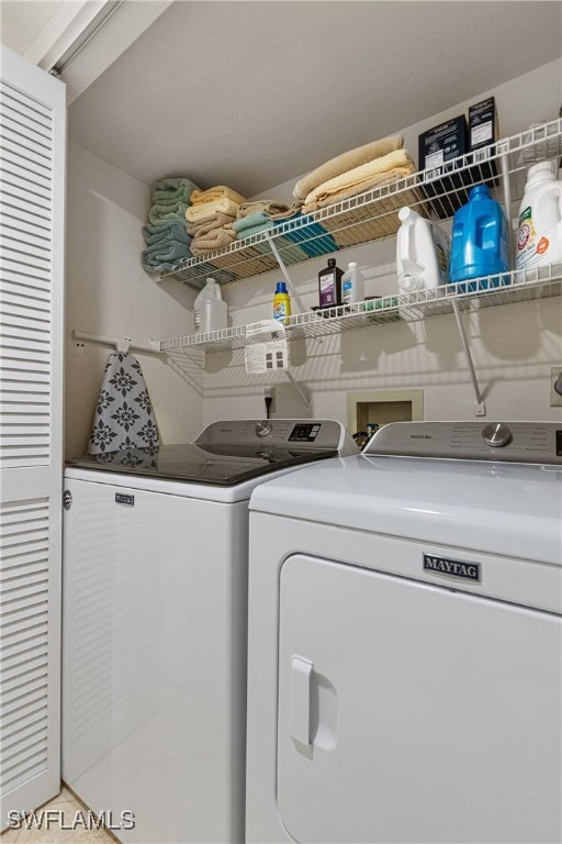 clothes washing area featuring independent washer and dryer