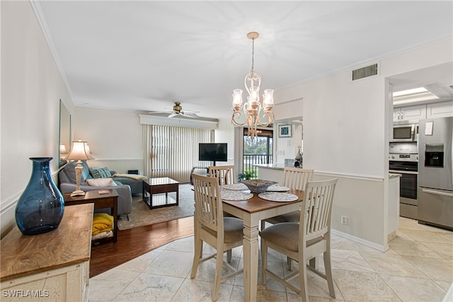 dining area with ceiling fan with notable chandelier, light wood-type flooring, and ornamental molding