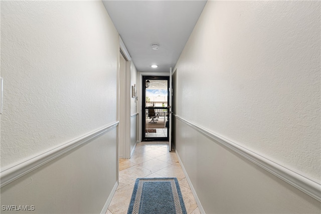 corridor featuring light tile patterned floors