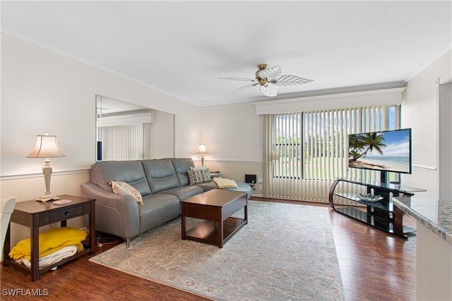 living room with ceiling fan, crown molding, and dark wood-type flooring