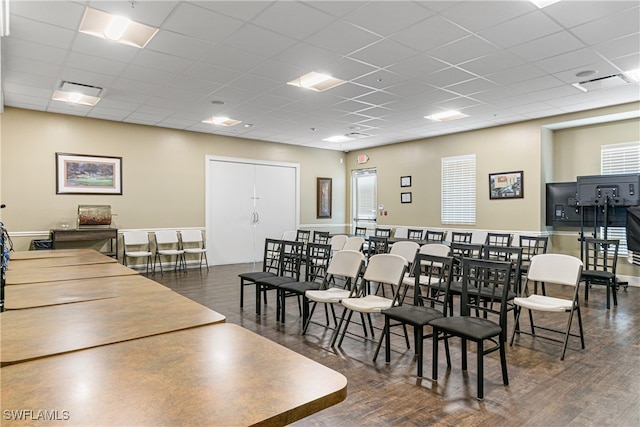 dining space featuring a paneled ceiling and dark hardwood / wood-style floors