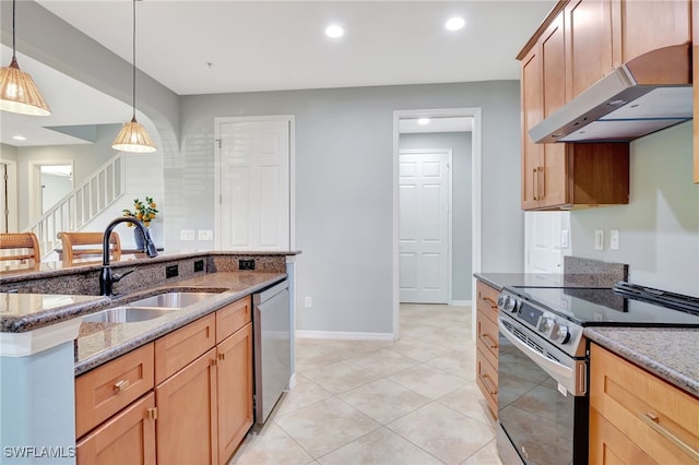 kitchen featuring pendant lighting, exhaust hood, appliances with stainless steel finishes, and dark stone counters