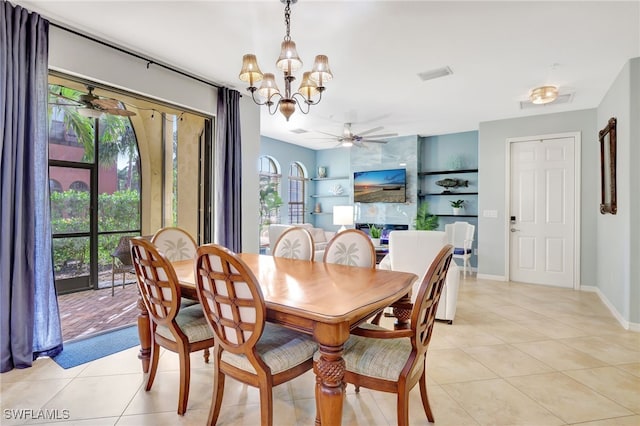 tiled dining area with built in shelves and ceiling fan with notable chandelier