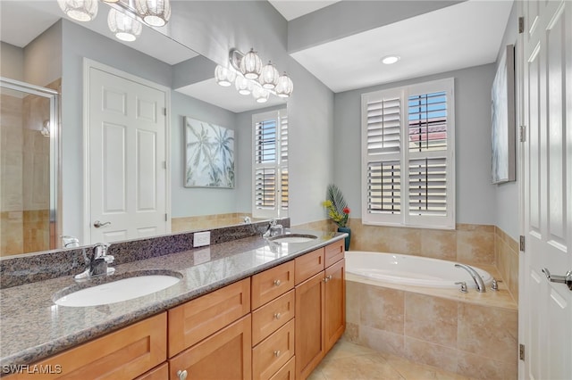 bathroom with tile patterned flooring, vanity, and plus walk in shower