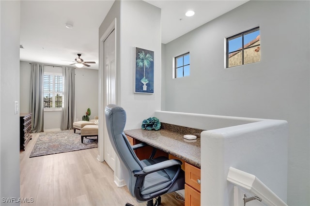 office space featuring ceiling fan and light wood-type flooring