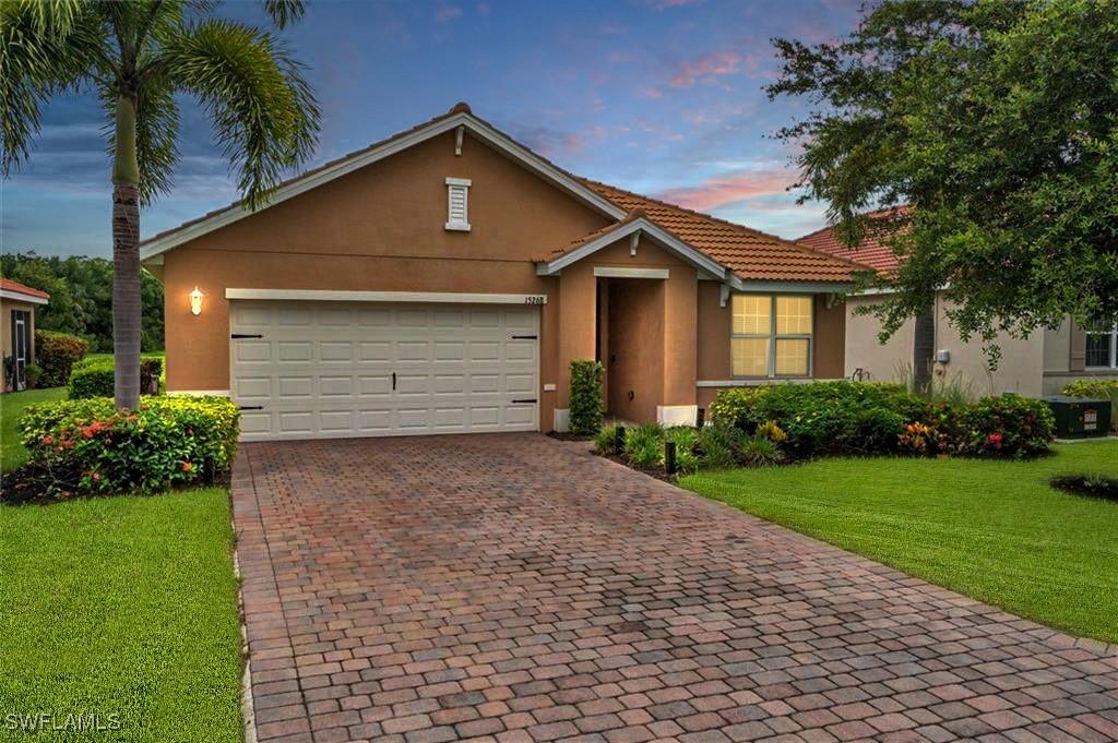 view of front of house with a garage and a lawn