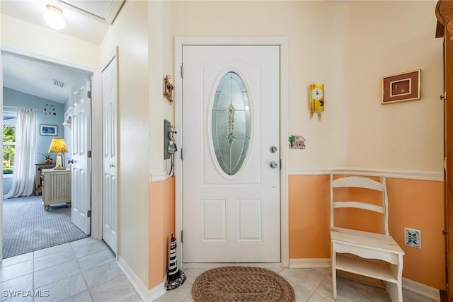 entrance foyer featuring vaulted ceiling and light tile patterned floors