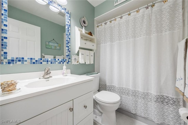 bathroom featuring toilet, backsplash, and vanity