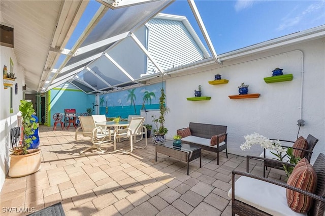 view of patio featuring glass enclosure and outdoor lounge area