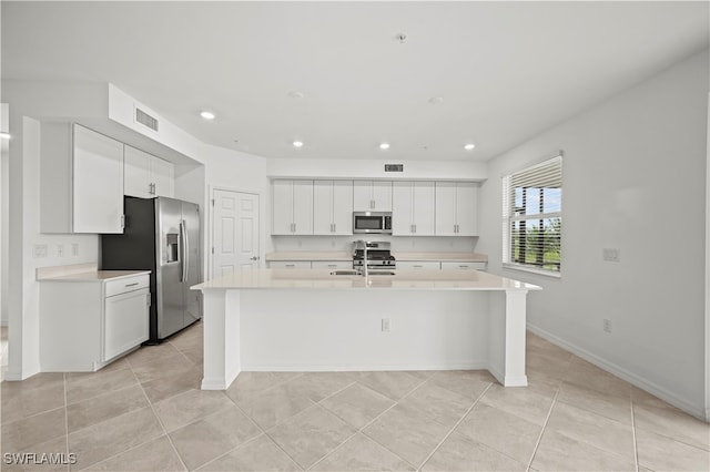 kitchen with sink, a center island with sink, white cabinets, and appliances with stainless steel finishes