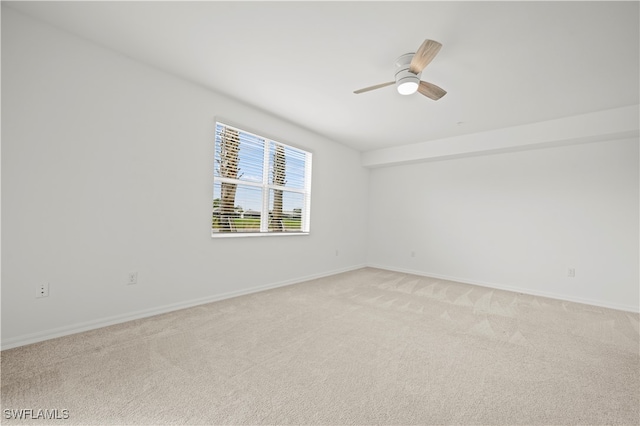 empty room with ceiling fan and light colored carpet