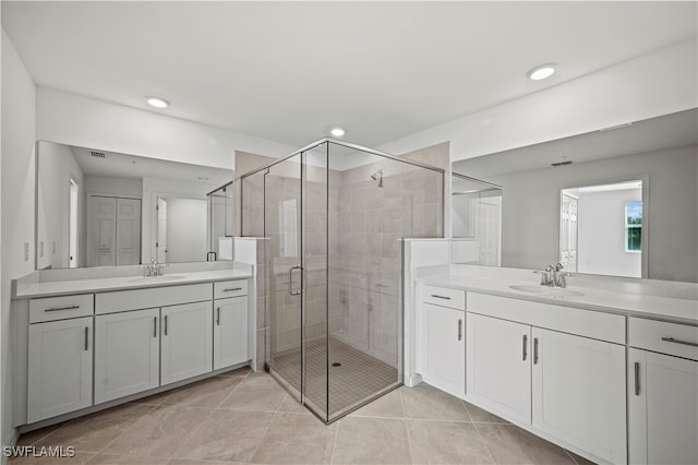 bathroom with tile patterned floors, vanity, and walk in shower