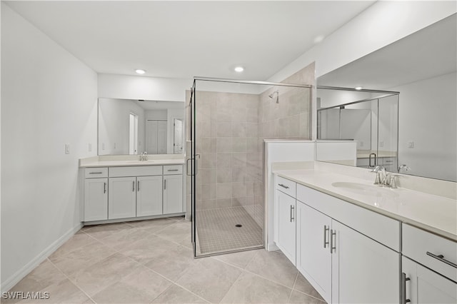 bathroom with tile patterned flooring, vanity, and an enclosed shower