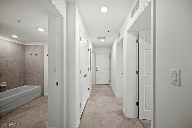 hall with light tile patterned floors